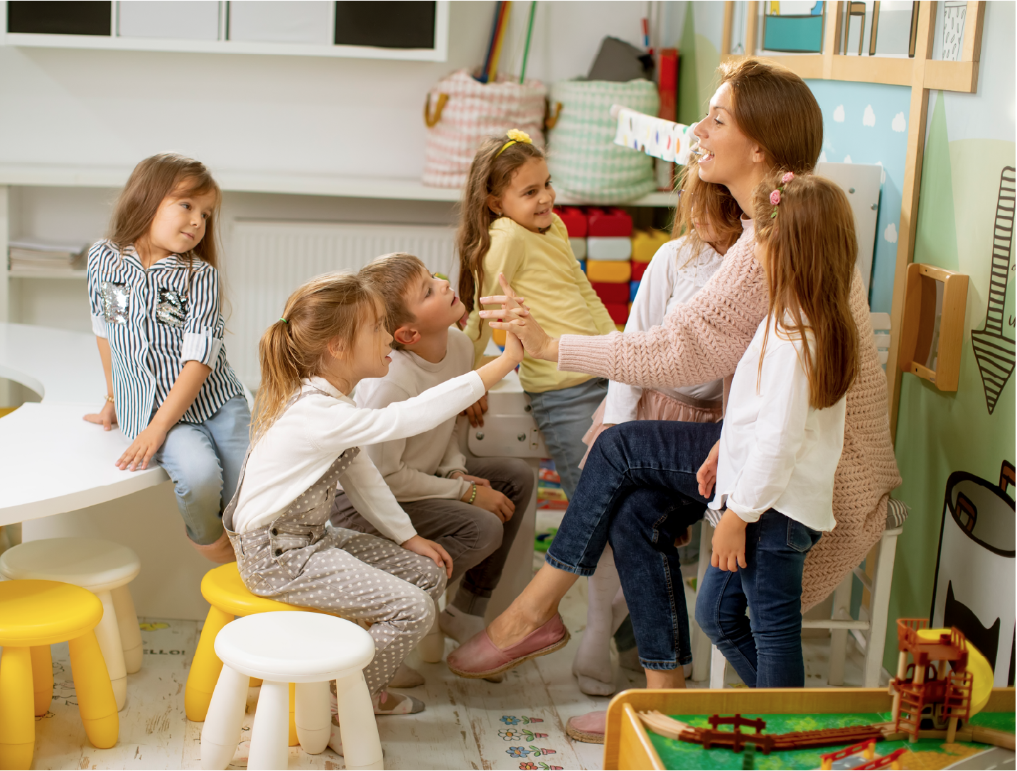 An educator interacting with children in a classroom